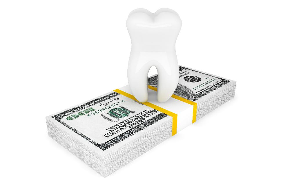 cartoon tooth on top of dollar bill | dental membership plans near me