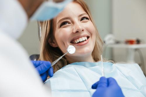 woman smiling in dentist exam chair | southampton ny dentist