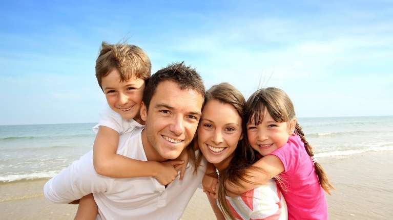 Family with their heathy teeth enjoying the beach in Southampton NY