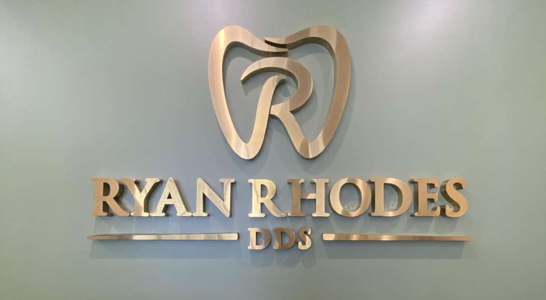 gold office signage of ryan rhodes dds | dentist in the hamptons